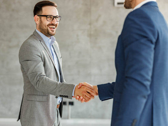 Happy businessmen came to an agreement in the office.